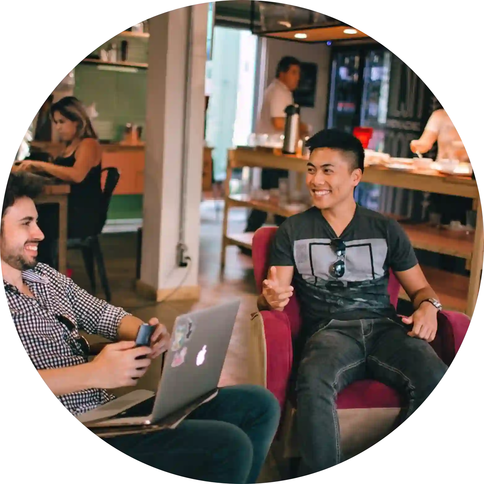 Professional workspace with two young men engaged in a discussion.